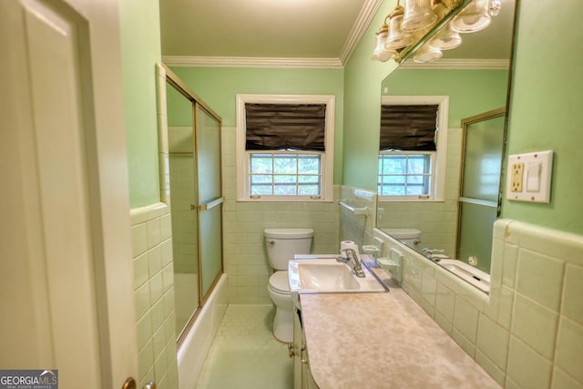 bathroom featuring wainscoting, toilet, and tile walls