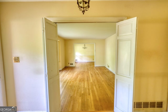 hall with visible vents and light wood-style flooring
