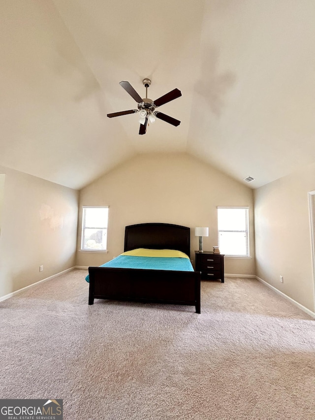 carpeted bedroom featuring visible vents, baseboards, vaulted ceiling, and a ceiling fan