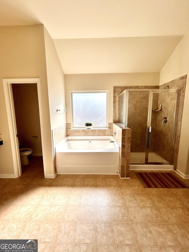 bathroom with toilet, a bath, a stall shower, and vaulted ceiling
