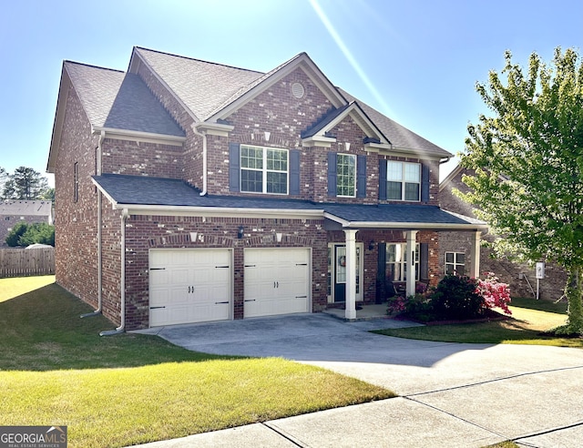 craftsman house featuring brick siding, a front lawn, a garage, and concrete driveway