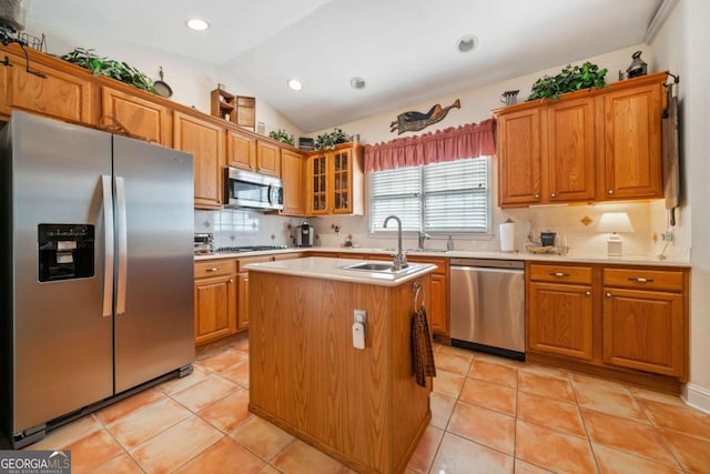 7420 Colony Ct, Cumming, GA 30041 - kitchen with brown cabinetry, vaulted ceiling, light countertops, a sink, and stainless steel appliances