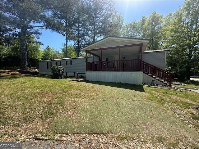 back of house with a yard, a porch, and stairway