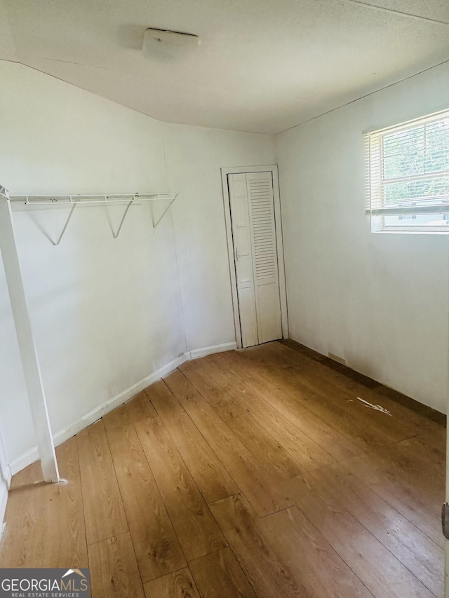 unfurnished bedroom featuring hardwood / wood-style floors