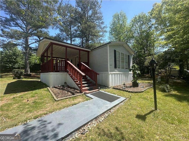 view of front of home with a front lawn and stairs