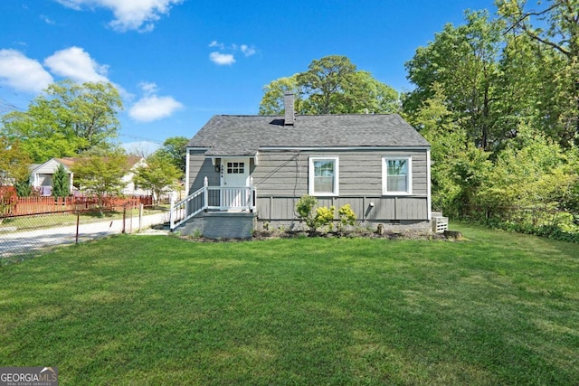 5024 Park Ave, Forest Park, GA 30297 - back of property with a chimney, fence, and a lawn