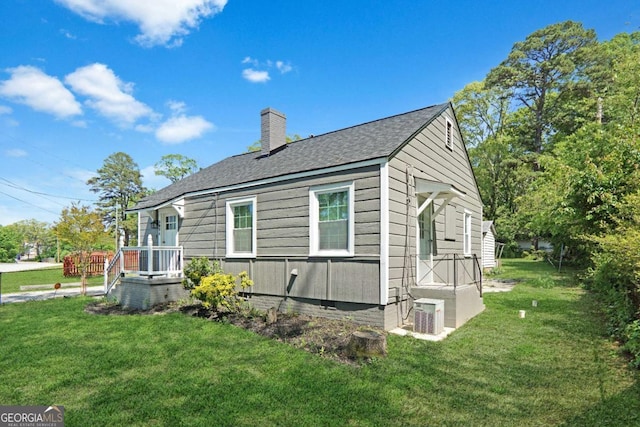 5024 Park Ave, Forest Park, GA 30297 - view of home's exterior featuring a yard, a shingled roof, and a chimney