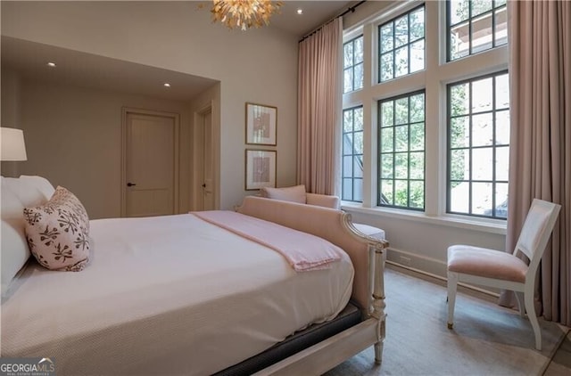 2979 Ridgewood Rd NW, Atlanta, GA 30327 - bedroom with carpet flooring, baseboards, recessed lighting, a high ceiling, and a chandelier