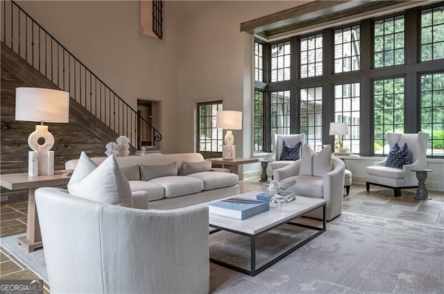 2979 Ridgewood Rd NW, Atlanta, GA 30327 - living room featuring a towering ceiling, stairs, and baseboards