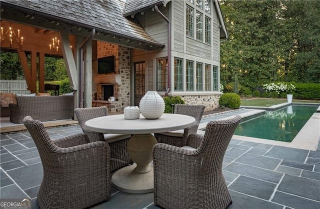 2979 Ridgewood Rd NW, Atlanta, GA 30327 - view of patio with exterior fireplace, an outdoor pool, and outdoor dining area
