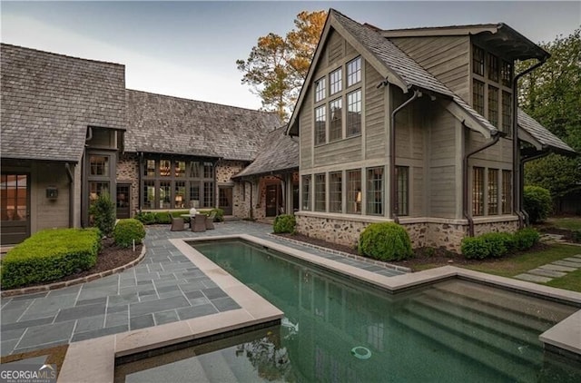2979 Ridgewood Rd NW, Atlanta, GA 30327 - rear view of property featuring a patio area, an outdoor pool, and brick siding