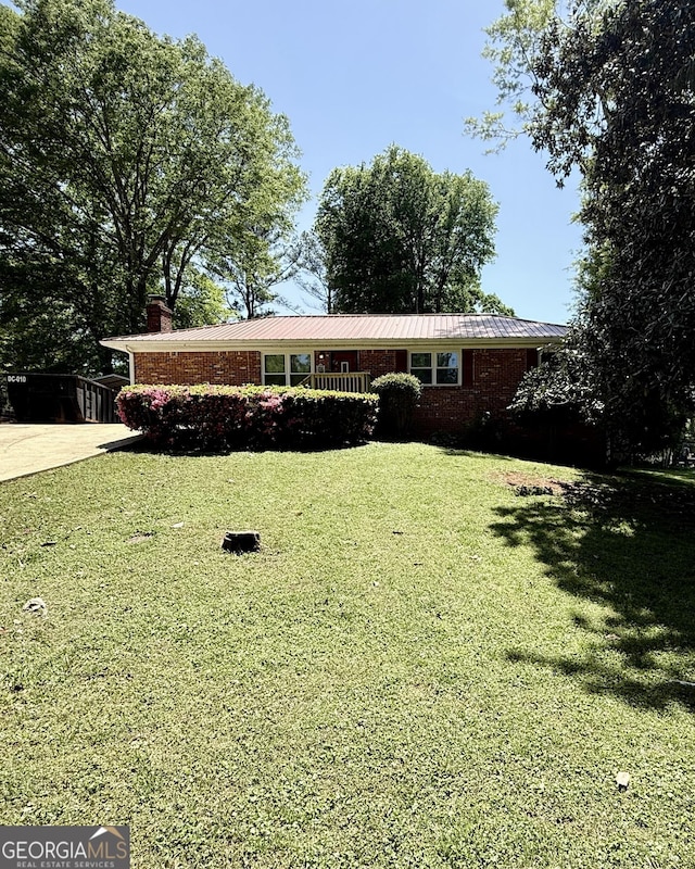 1093 Grace St SW, Mableton, GA 30126 - ranch-style home with brick siding, a front lawn, metal roof, and a chimney