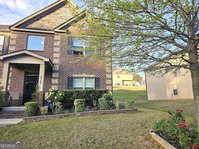 view of front of house featuring a front yard and brick siding
