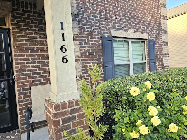 view of exterior entry with brick siding