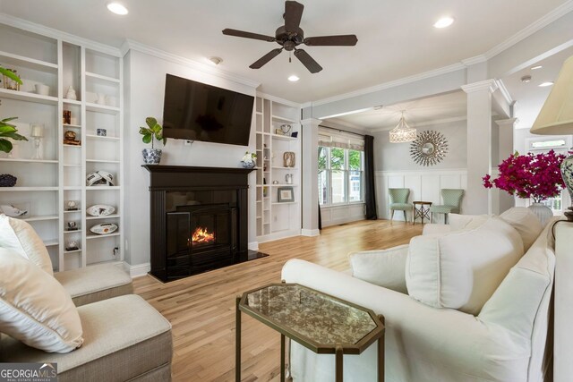 2238 Parkview Ct NW, Atlanta, GA 30318 - living room featuring crown molding, ornate columns, ceiling fan, and wood finished floors