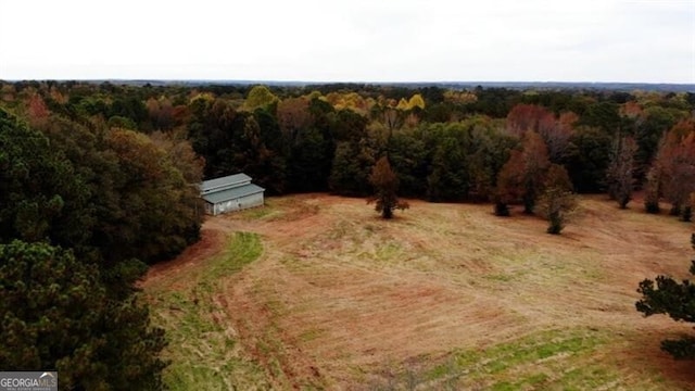 birds eye view of property featuring a view of trees