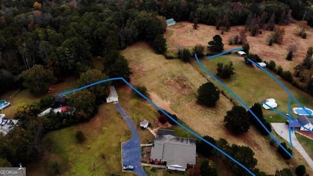 birds eye view of property with a view of trees