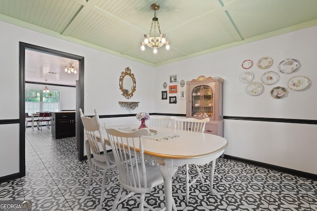 387 Sandhurst Dr, Richmond Hill, GA 31324 - dining area with tile patterned floors, wooden ceiling, an inviting chandelier, and baseboards