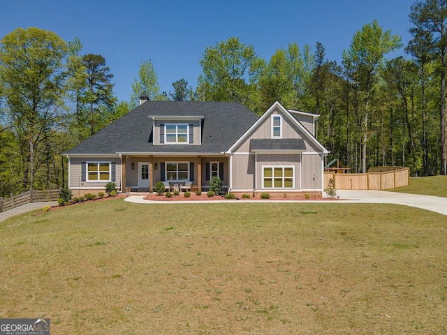 craftsman inspired home featuring a shingled roof, a chimney, fence, and a front lawn