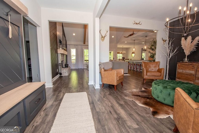 interior space featuring dark wood-type flooring and a notable chandelier