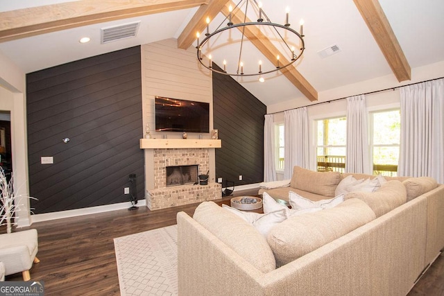 living area with beam ceiling, visible vents, and a notable chandelier