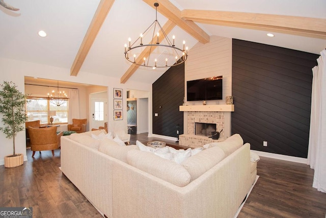 living area with lofted ceiling with beams, a chandelier, a fireplace, wooden walls, and dark wood-style floors
