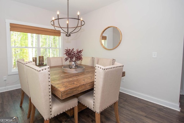 dining area featuring baseboards, a chandelier, and dark wood-style floors