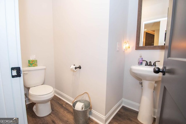 bathroom featuring baseboards, toilet, and wood finished floors