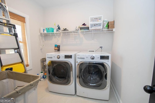 washroom with independent washer and dryer, laundry area, and baseboards