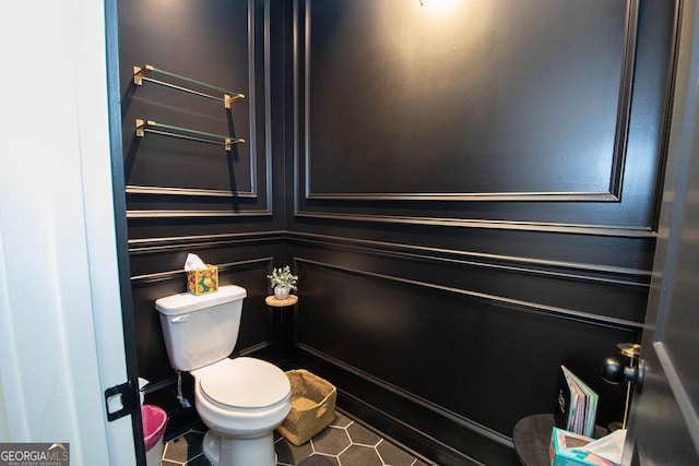bathroom featuring toilet and tile patterned floors