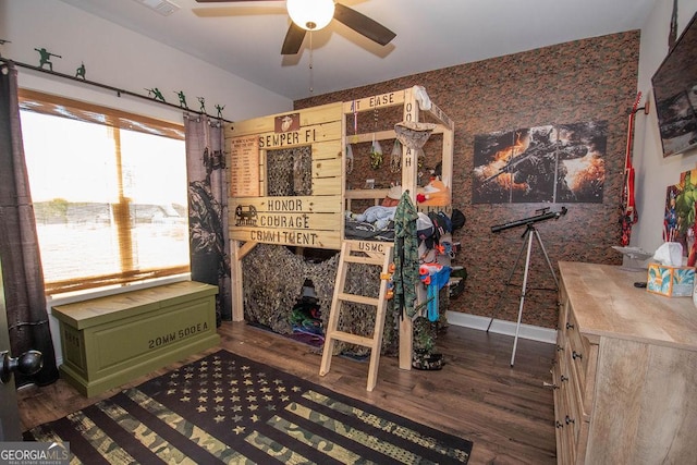 bedroom with wallpapered walls, dark wood-style flooring, and baseboards