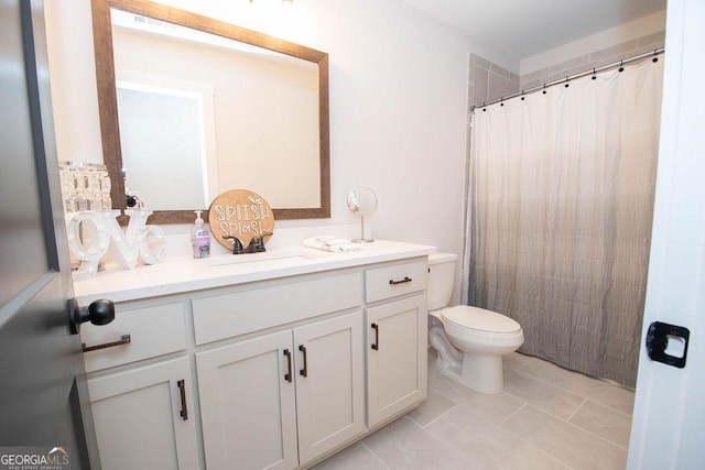 bathroom featuring toilet, vanity, tile patterned flooring, and a shower with curtain