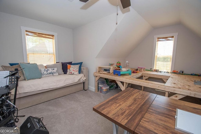 interior space with ceiling fan, baseboards, lofted ceiling, and carpet floors