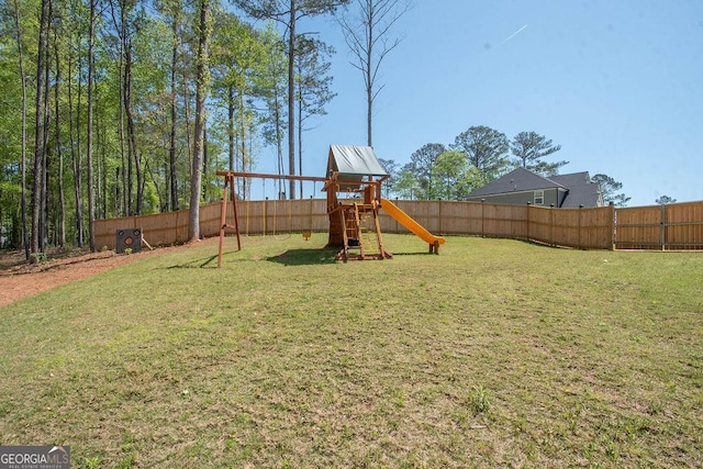 view of yard with fence and a playground