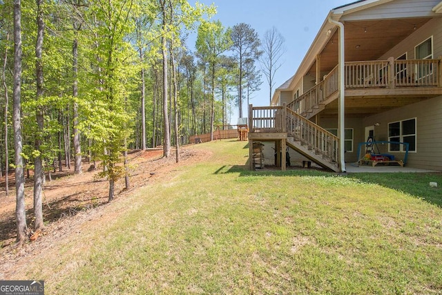 view of yard with a wooden deck and stairway