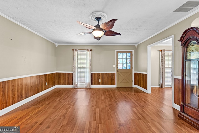 324 County Line Rd, Fayetteville, GA 30215 - empty room featuring a ceiling fan, wood finished floors, a textured ceiling, wainscoting, and visible vents