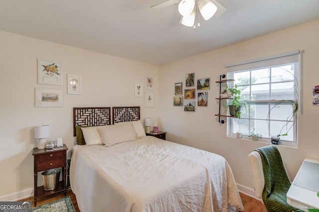 bedroom featuring baseboards, a ceiling fan, and wood finished floors