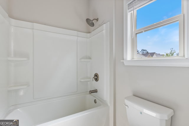 bathroom with a shower and toilet