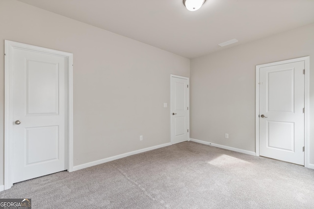 unfurnished bedroom featuring baseboards and carpet flooring