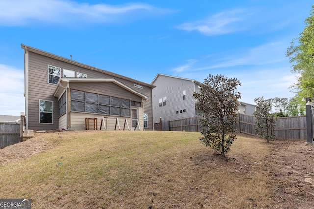 back of property featuring a yard and a fenced backyard