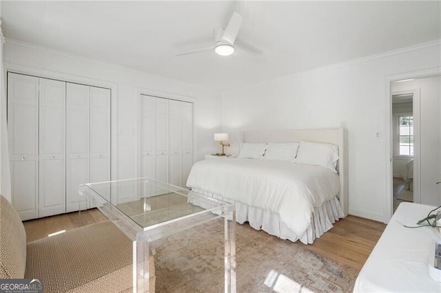 1305 Old Woodbine Rd, Atlanta, GA 30319 - bedroom featuring light wood-type flooring, ornamental molding, and multiple closets