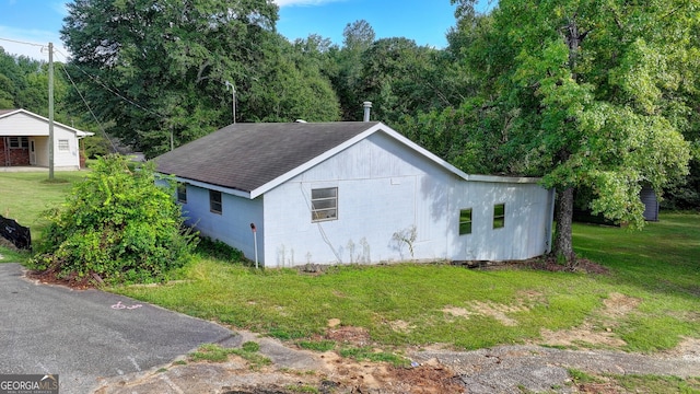 5680 Abbotts Bridge Rd, Johns Creek, GA 30097 - exterior space with concrete block siding, a lawn, and roof with shingles