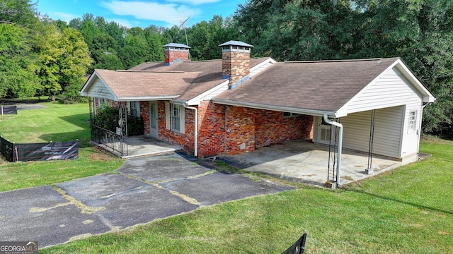 5680 Abbotts Bridge Rd, Johns Creek, GA 30097 - single story home featuring aphalt driveway, covered porch, a carport, a front lawn, and a chimney