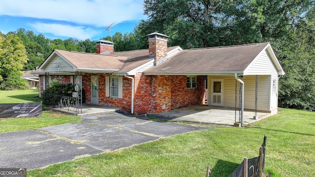 5680 Abbotts Bridge Rd, Johns Creek, GA 30097 - single story home featuring a carport, a front lawn, brick siding, a chimney, and driveway