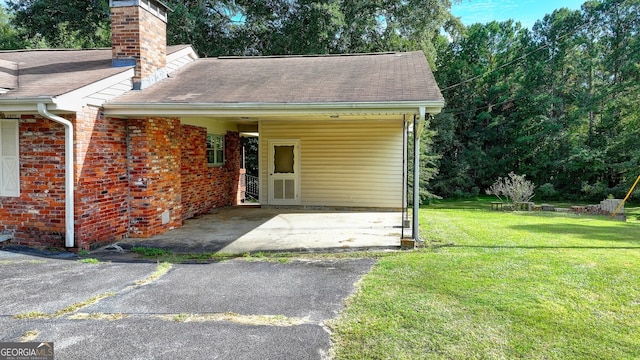 5680 Abbotts Bridge Rd, Johns Creek, GA 30097 - exterior space featuring a chimney, an attached carport, aphalt driveway, brick siding, and a lawn