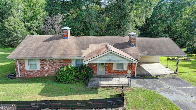 5680 Abbotts Bridge Rd, Johns Creek, GA 30097 - view of front of house with an attached carport, aphalt driveway, a chimney, and a front lawn