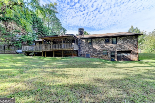 5680 Abbotts Bridge Rd, Johns Creek, GA 30097 - back of house with central air condition unit, a chimney, a ceiling fan, brick siding, and a lawn