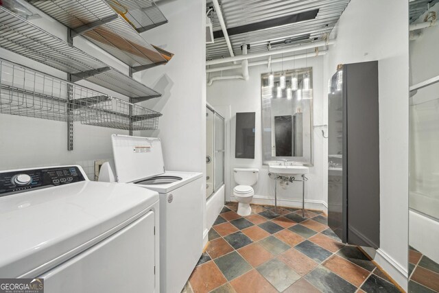 120 Ralph Mcgill Blvd NE Unit 1304 & 1305, Atlanta, GA 30308 - laundry area featuring washer and dryer, dark stone finish flooring, and electric panel