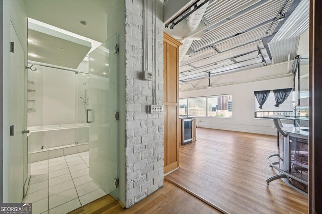 120 Ralph Mcgill Blvd NE Unit 1304 & 1305, Atlanta, GA 30308 - bathroom featuring wood finished floors, beverage cooler, and a stall shower