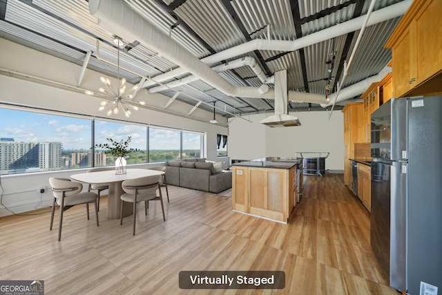120 Ralph Mcgill Blvd NE Unit 1304 & 1305, Atlanta, GA 30308 - kitchen featuring freestanding refrigerator, a chandelier, dark countertops, light wood-type flooring, and a kitchen island